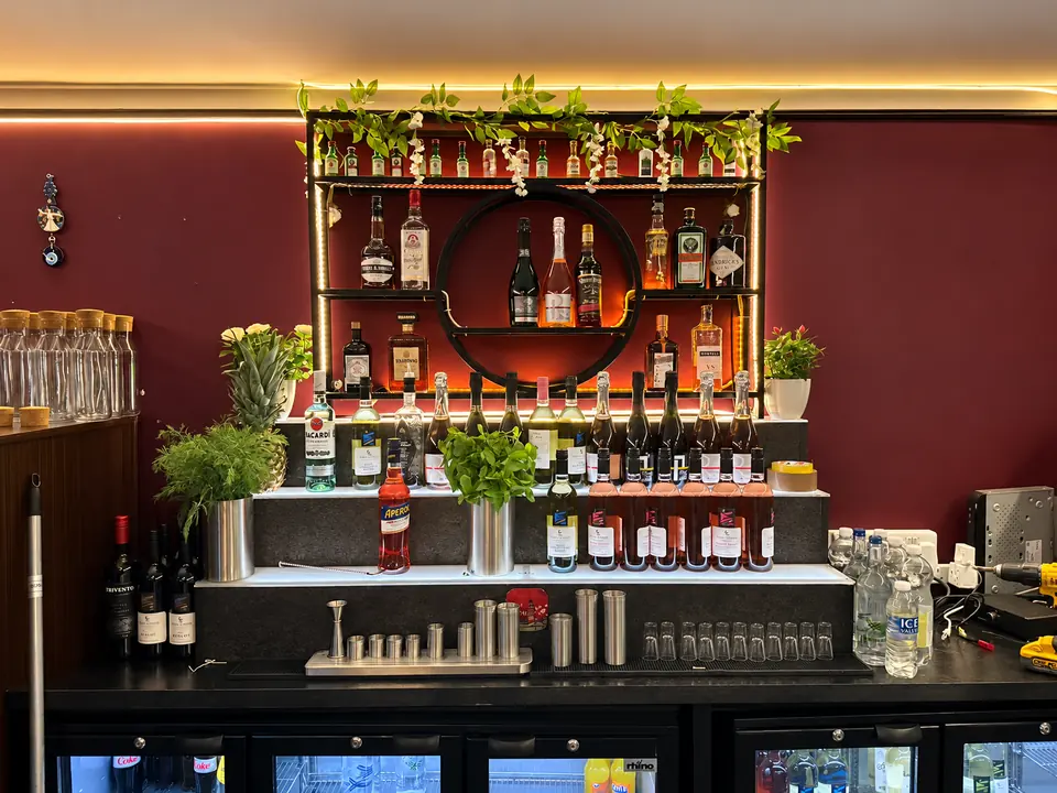 The back bar with bottles and greenery