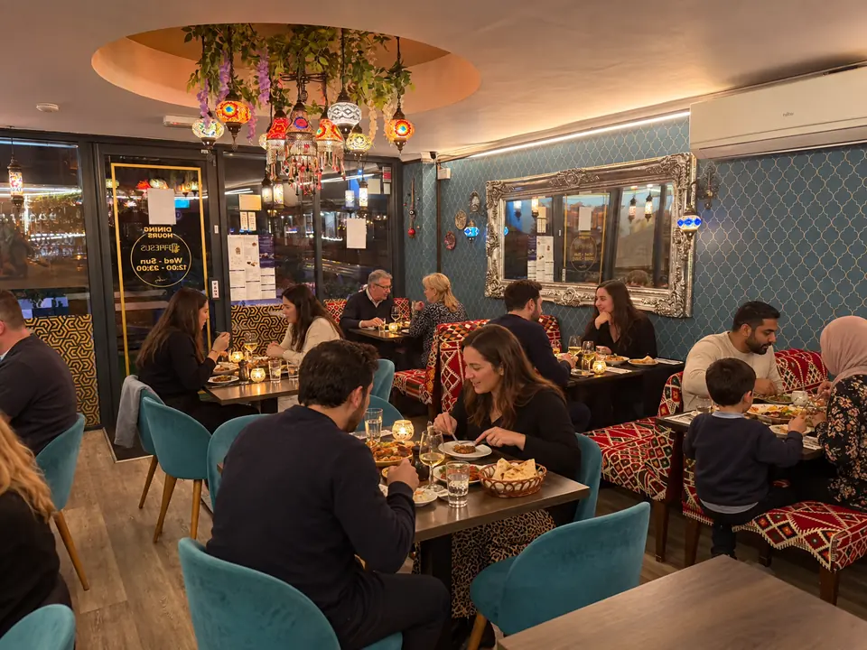 Kilim-pattern booths and tables by the front windows