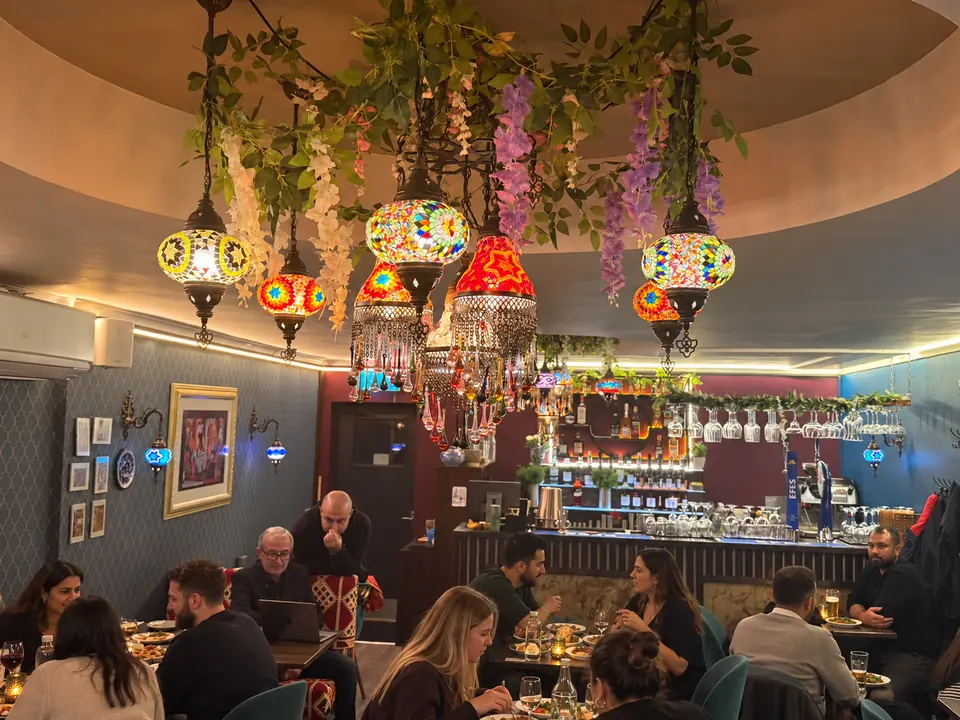 Turkish mosaic lamps and hanging flowers over the dining room and bar
