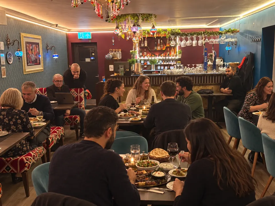 A busy evening in the dining room, with the bar behind